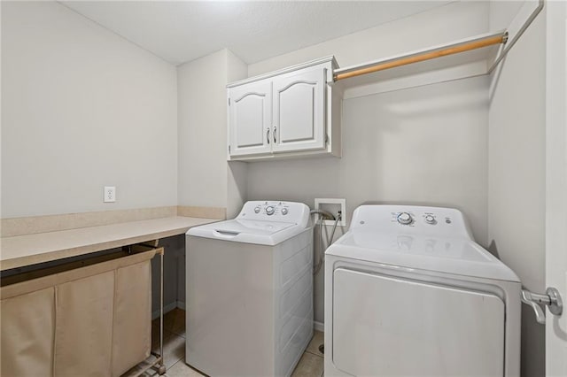 5108 W 150th St, Leawood, KS 66224 - laundry room with cabinet space, washing machine and clothes dryer, and light tile patterned floors