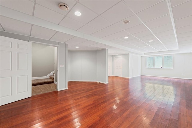 5108 W 150th St, Leawood, KS 66224 - below grade area featuring wood finished floors, stairway, and a drop ceiling