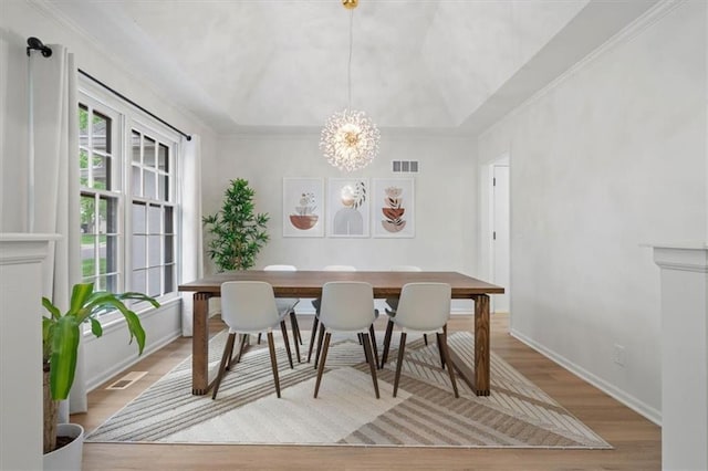 dining space featuring a healthy amount of sunlight, a notable chandelier, and visible vents