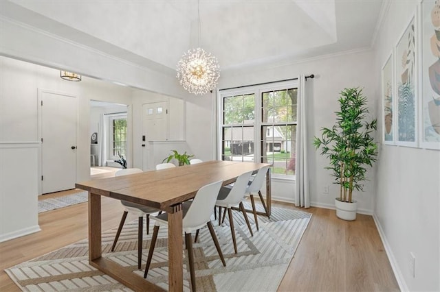 dining area featuring an inviting chandelier, light wood-type flooring, and a healthy amount of sunlight