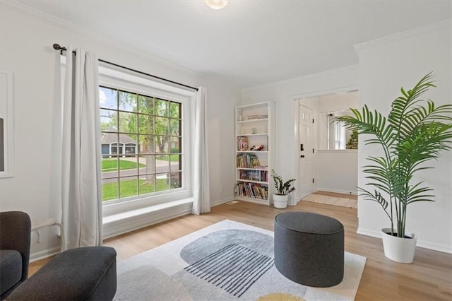 entryway with baseboards, ornamental molding, and wood finished floors