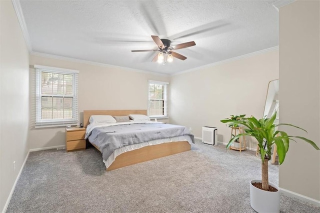 carpeted bedroom featuring crown molding, baseboards, ceiling fan, and a textured ceiling