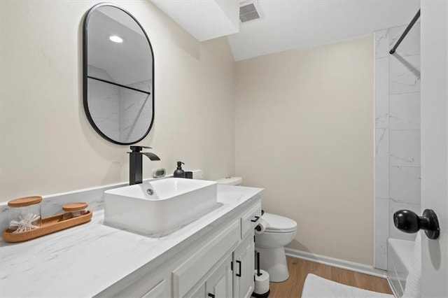 bathroom featuring shower / tub combination, vanity, toilet, wood finished floors, and visible vents