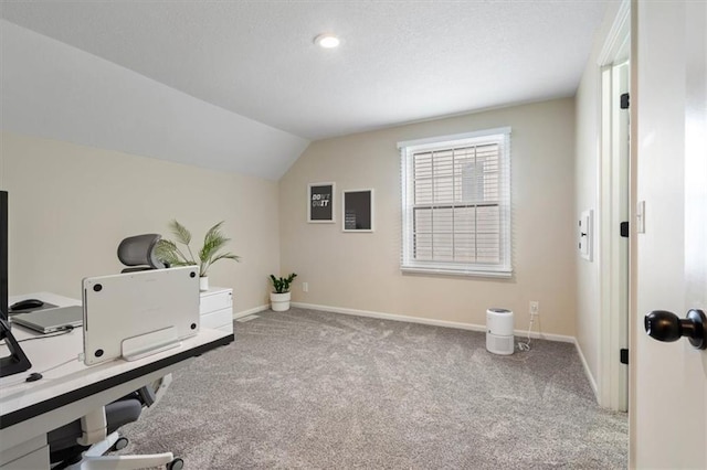 office area with carpet floors, a textured ceiling, baseboards, and lofted ceiling