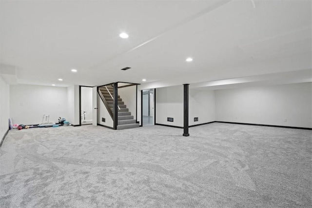 finished basement featuring recessed lighting, carpet, and stairway