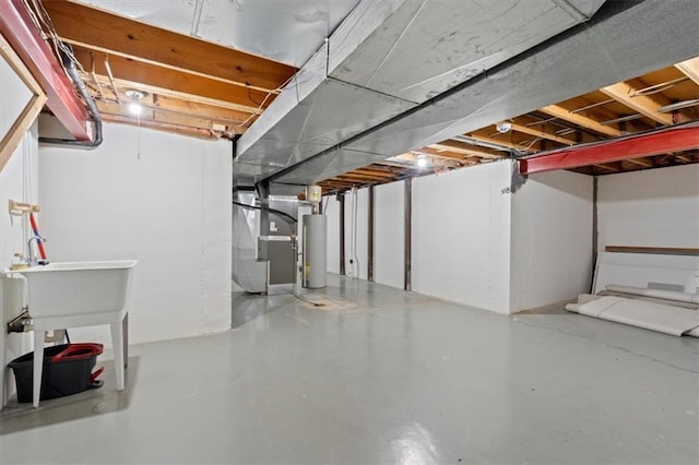 unfinished basement with water heater and heating unit