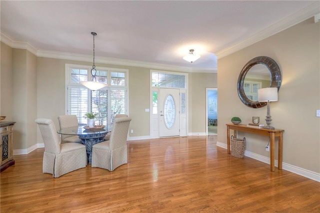 foyer entrance featuring light wood-type flooring, baseboards, and crown molding