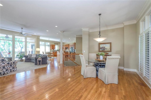 dining space featuring light wood-style flooring, a ceiling fan, baseboards, recessed lighting, and ornamental molding