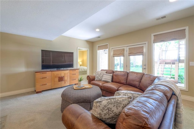 living area with recessed lighting, baseboards, visible vents, and light carpet