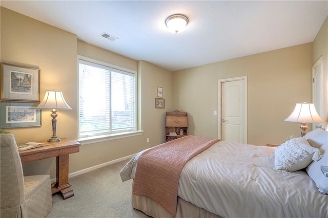 carpeted bedroom with visible vents and baseboards