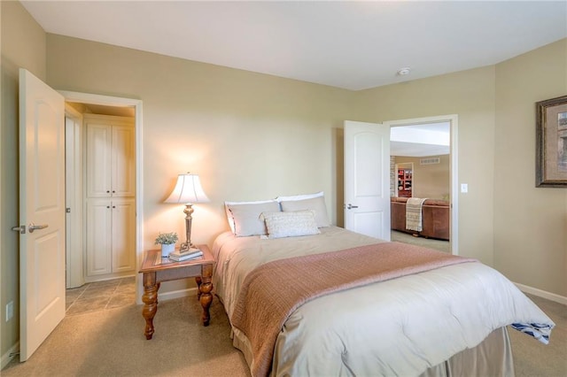 bedroom with light colored carpet, baseboards, and visible vents