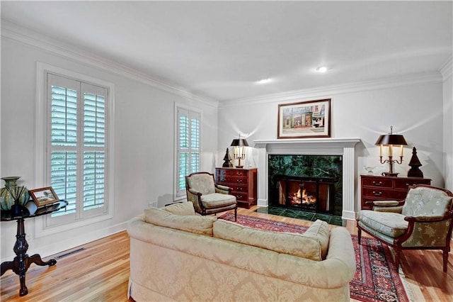 11405 Manor St, Leawood, KS 66211 - living room featuring wood finished floors, plenty of natural light, crown molding, and a high end fireplace