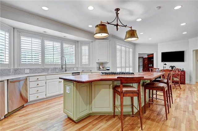 11405 Manor St, Leawood, KS 66211 - kitchen with a sink, stainless steel appliances, healthy amount of natural light, crown molding, and a center island