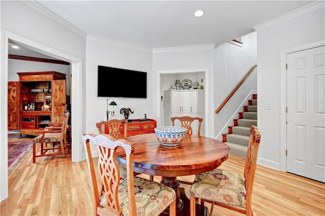 11405 Manor St, Leawood, KS 66211 - dining room with light wood-style flooring, stairway, ornamental molding, recessed lighting, and baseboards
