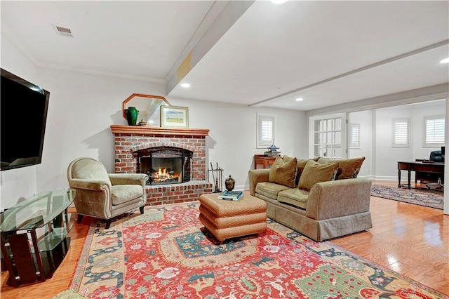 11405 Manor St, Leawood, KS 66211 - living room featuring light wood finished floors, a brick fireplace, recessed lighting, crown molding, and baseboards