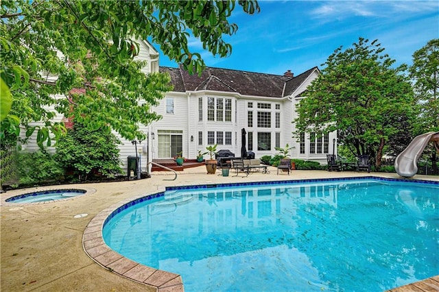 11405 Manor St, Leawood, KS 66211 - outdoor pool with a water slide, an in-ground hot tub, and a patio area