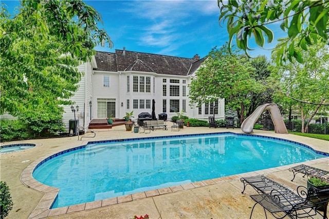 11405 Manor St, Leawood, KS 66211 - outdoor pool featuring an in-ground hot tub, a patio, and a water slide