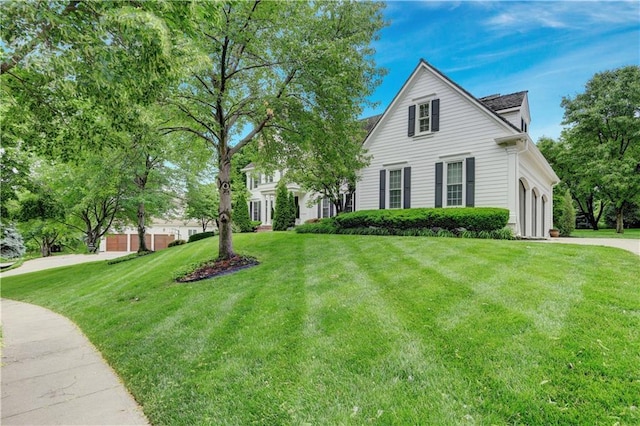 11405 Manor St, Leawood, KS 66211 - view of front of property featuring a front lawn, a garage, and driveway