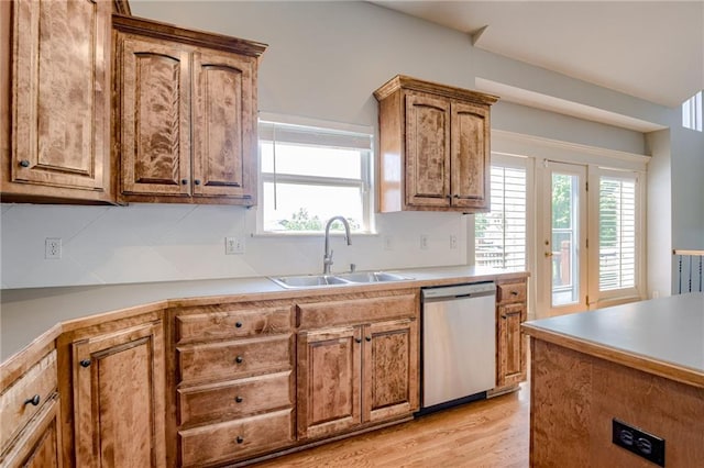 496 S 137th St, Bonner Springs, KS 66012 - kitchen with stainless steel dishwasher, a sink, plenty of natural light, and brown cabinets