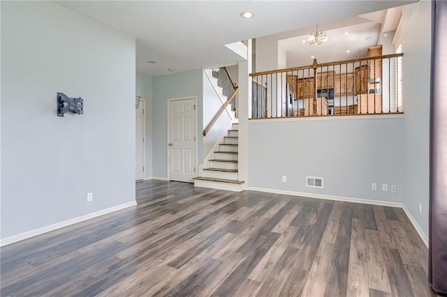 496 S 137th St, Bonner Springs, KS 66012 - unfurnished living room featuring a chandelier, wood finished floors, baseboards, stairway, and recessed lighting