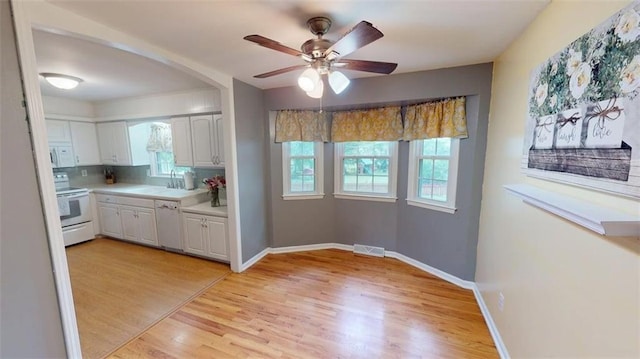 11706 W 69th St, Shawnee, KS 66203 - kitchen with white appliances, white cabinets, light wood finished floors, and light countertops