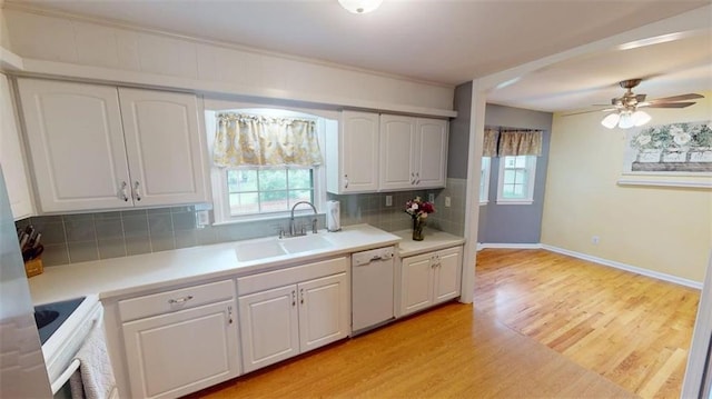 11706 W 69th St, Shawnee, KS 66203 - kitchen featuring dishwasher, a sink, plenty of natural light, and white cabinetry