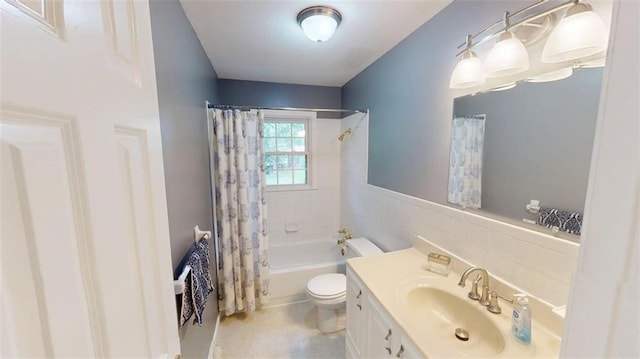 11706 W 69th St, Shawnee, KS 66203 - bathroom featuring toilet, vanity, shower / bathtub combination with curtain, tile walls, and wainscoting