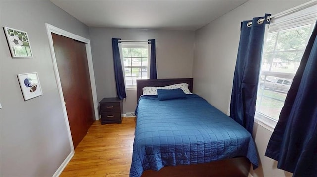 11706 W 69th St, Shawnee, KS 66203 - bedroom with light wood finished floors, baseboards, and a closet