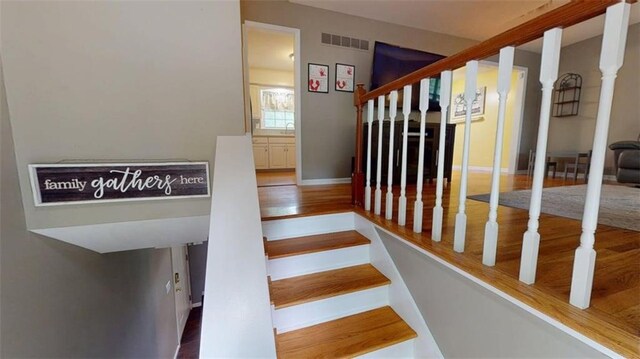 11706 W 69th St, Shawnee, KS 66203 - stairway featuring wood finished floors and baseboards