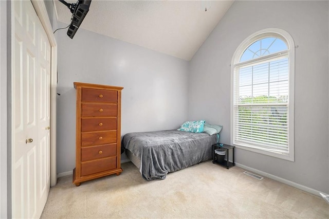 carpeted bedroom featuring visible vents, baseboards, vaulted ceiling, and multiple windows