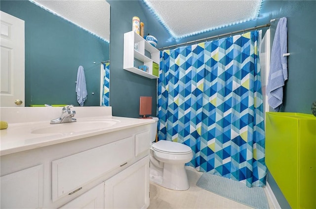 full bathroom featuring a textured ceiling, curtained shower, vanity, tile patterned floors, and toilet
