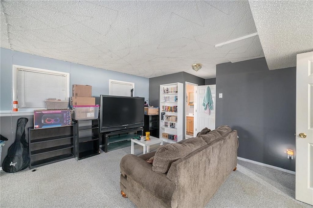 carpeted living area with baseboards