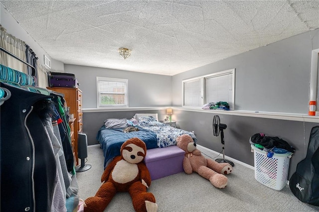 carpeted bedroom featuring baseboards