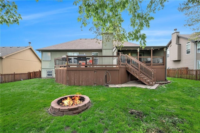back of property featuring a deck, stairs, a fenced backyard, and an outdoor fire pit