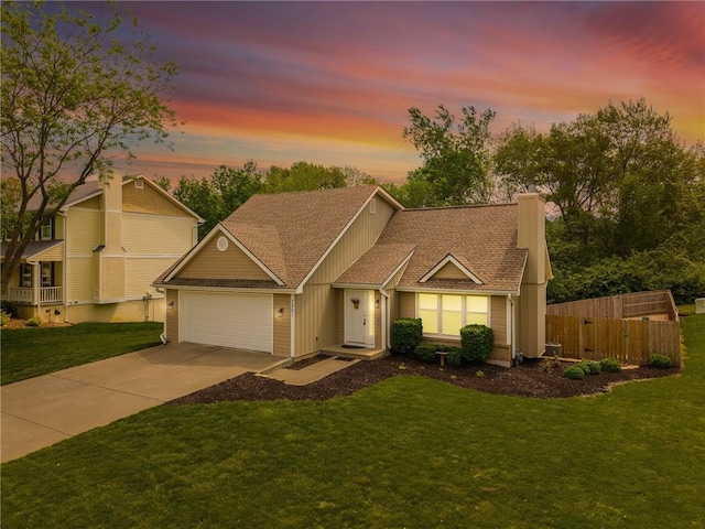 view of front of property with a lawn, a garage, fence, concrete driveway, and a shingled roof