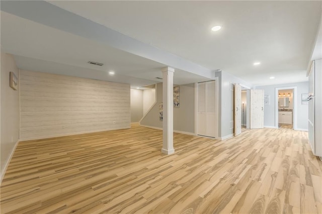 finished basement featuring recessed lighting, baseboards, visible vents, and light wood-type flooring