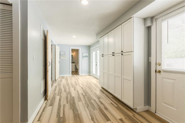 corridor featuring recessed lighting, baseboards, light wood-type flooring, and visible vents