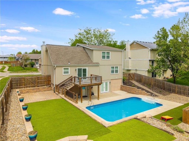 rear view of house featuring a wooden deck, a fenced backyard, a residential view, a patio area, and stairway