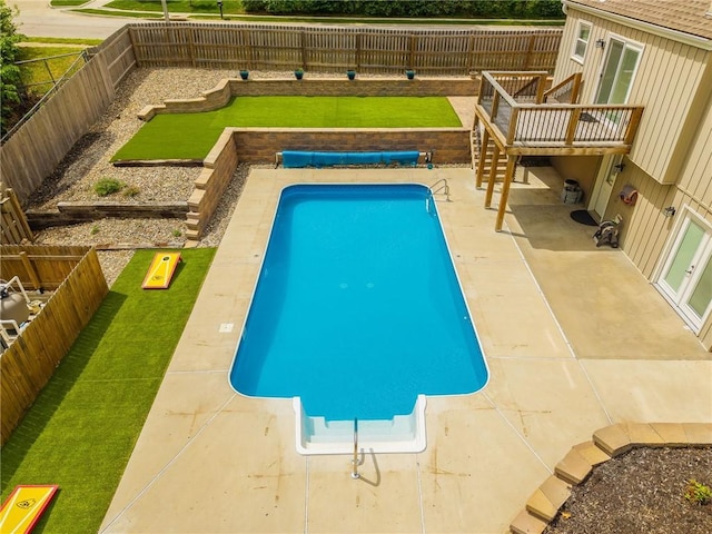view of pool with a wooden deck, a patio area, a fenced in pool, a fenced backyard, and a yard