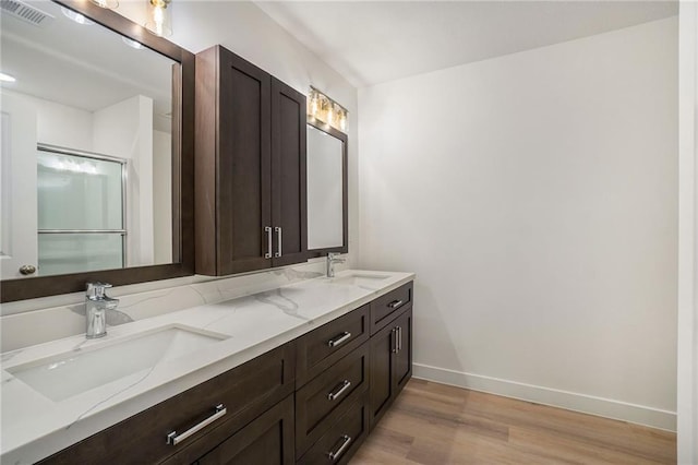3806-3808 NW 93rd St, Kansas City, MO 64132 - full bathroom featuring wood finished floors, baseboards, and double vanity
