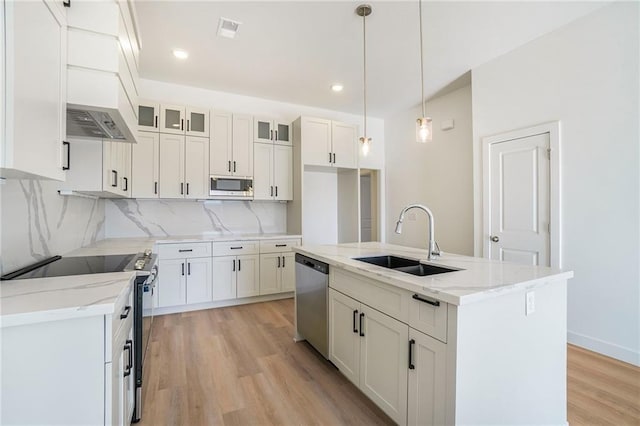 3806-3808 NW 93rd St, Kansas City, MO 64132 - kitchen featuring appliances with stainless steel finishes, a sink, light wood-style flooring, white cabinets, and backsplash