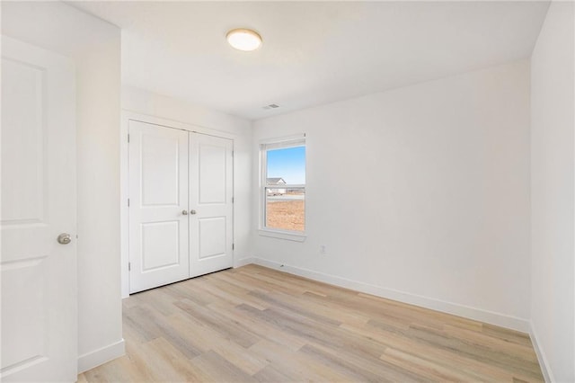 3806-3808 NW 93rd St, Kansas City, MO 64132 - unfurnished bedroom featuring light wood-type flooring, baseboards, and a closet