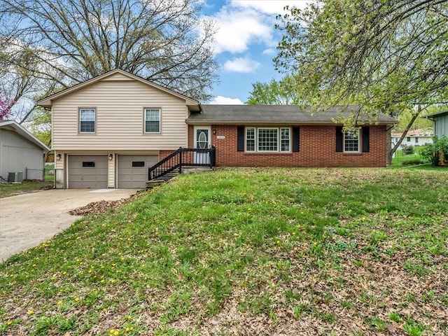 tri-level home featuring central AC unit, brick siding, driveway, and a garage