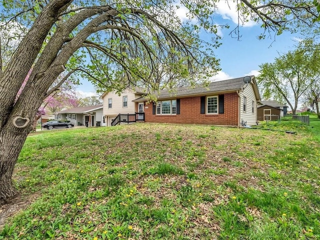 view of front facade featuring a front lawn and brick siding