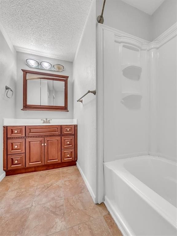 full bath featuring baseboards, vanity, a textured ceiling, and shower / bath combination