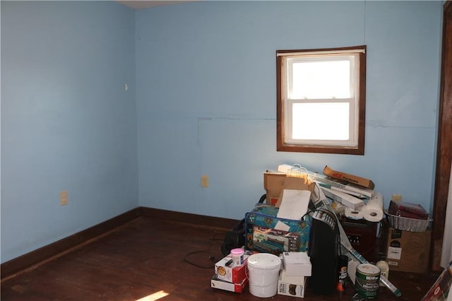 empty room with baseboards and wood finished floors