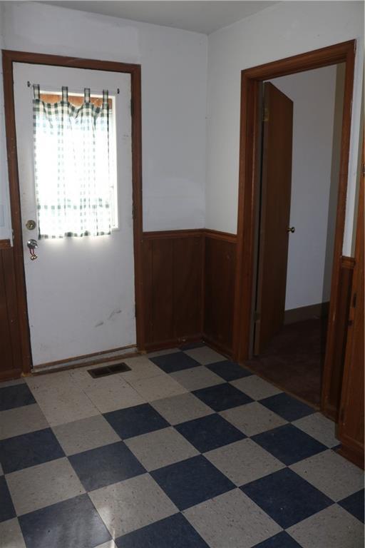 spare room featuring wainscoting and visible vents