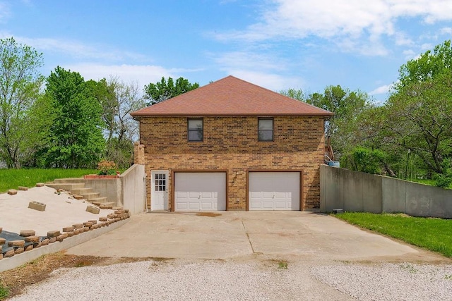 34701 E 235th St, Pleasant Hill, MO 64080 - view of side of home featuring brick siding, a garage, fence, and driveway