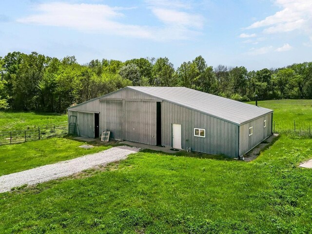 34701 E 235th St, Pleasant Hill, MO 64080 - view of pole building with a yard, fence, and gravel driveway