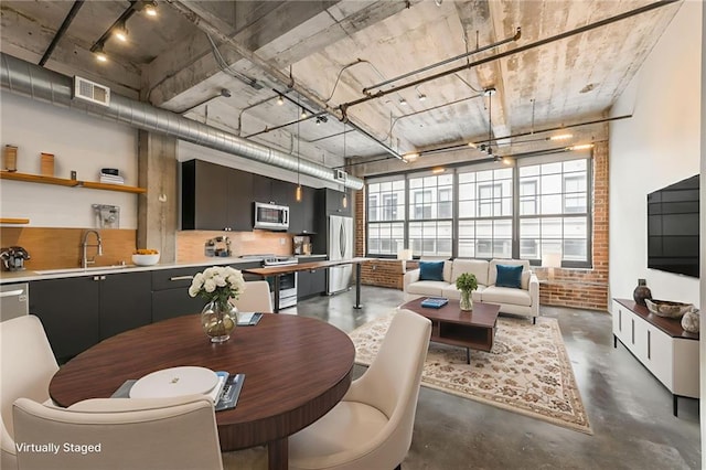 715 May St Unit 328, Kansas City, MO 64105 - dining area with concrete flooring and brick wall